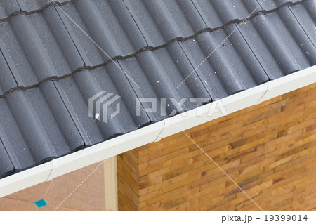 white gutter on the roof top of house 19399014
