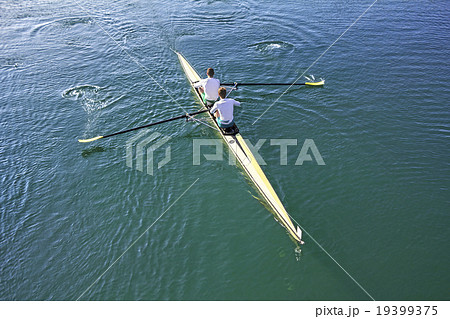 Two rowers in a boat 19399375