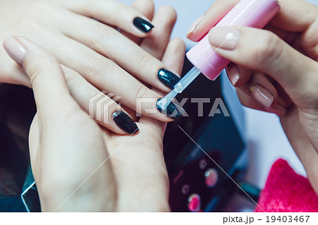 Manicure. Beauty saloon. Close-up. Apply black Manicure. Beauty saloon. Close-up. Apply black 19403467