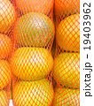 Fresh oranges in Mesh bag close up 19403962