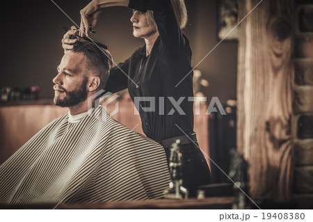 Client visiting hairstylist in barber shop 19408380