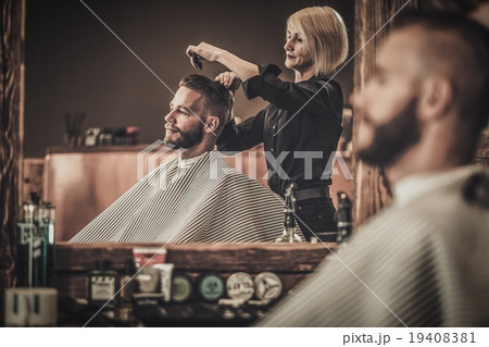 Client visiting hairstylist in barber shop Client visiting hairstylist in barber shop 19408381