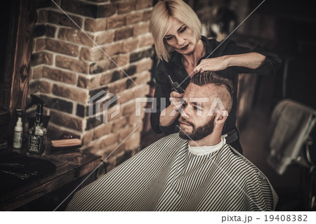 Client visiting hairstylist in barber shop 19408382