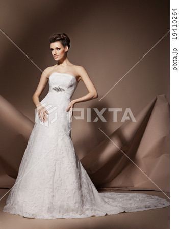 The beautiful young woman in a wedding dress 19410264