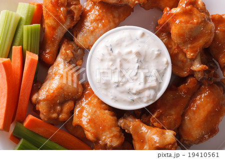 Buffalo wings with sauce on a plate macro 19410561