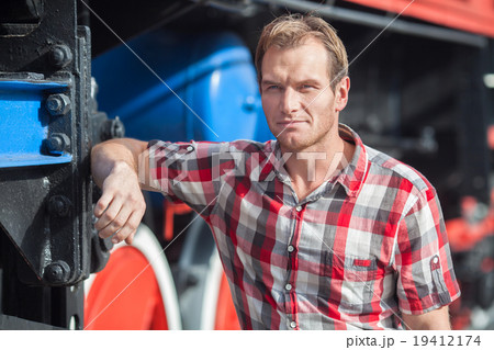 Portrait of man in a checkered shirt near the old Portrait of man in a checkered shirt near the old 19412174