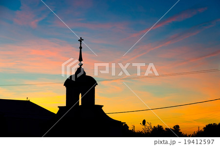 Silhouette of church against the colorful sunset 19412597