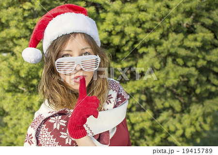 Beautiful Santa Claus girl with finger on her lips 19415789