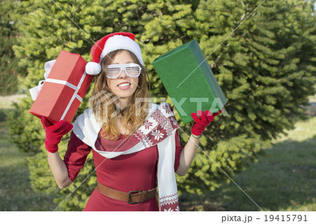 Beautiful Santa Claus girl with Christmas presents Beautiful Santa Claus girl with Christmas presents 19415791