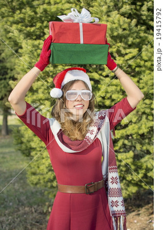 Beautiful Santa Claus girl with Christmas presents Beautiful Santa Claus girl with Christmas presents 19415792