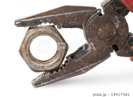 Closeup of old pliers and nut 19417581