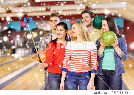 happy friends taking selfie in bowling club 19443059