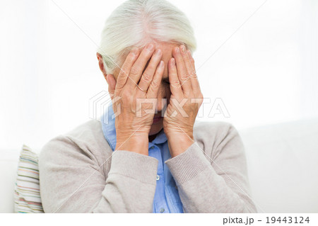 senior woman suffering from headache or grief senior woman suffering from headache or grief 19443124