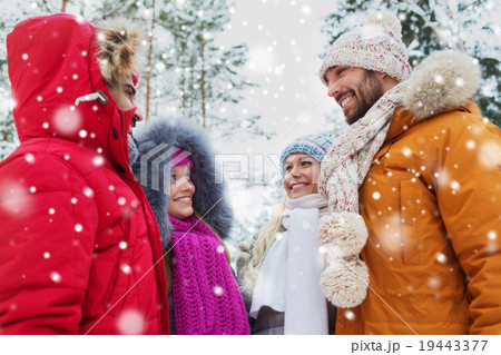 group of smiling men and women in winter forest group of smiling men and women in winter forest 19443377