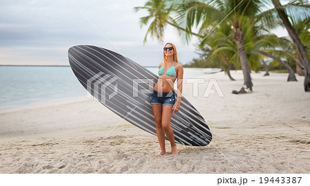 smiling young woman with surfboard on summer beach smiling young woman with surfboard on summer beach 19443387