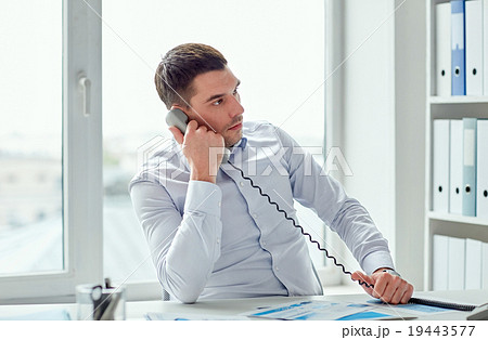 angry businessman calling on phone in office angry businessman calling on phone in office 19443577