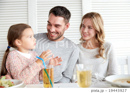 happy family having dinner at restaurant or cafe 19443927