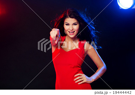 sexy woman in red pointing on you at nightclub sexy woman in red pointing on you at nightclub 19444442