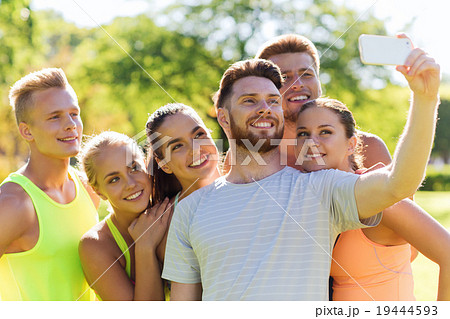 happy friends taking selfie with smartphone 19444593