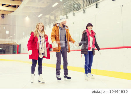 happy friends on skating rink 19444659