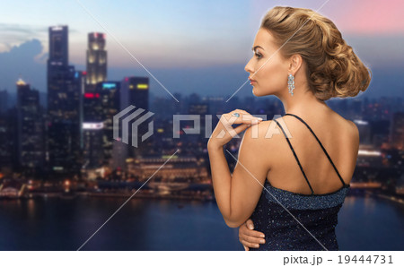 woman with diamond earring over night city woman with diamond earring over night city 19444731