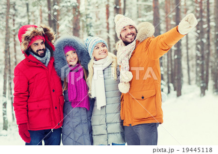 group of smiling men and women in winter forest group of smiling men and women in winter forest 19445118