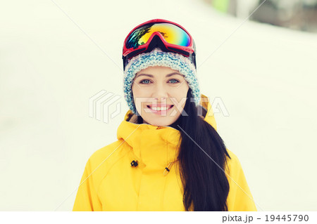 happy young woman in ski goggles outdoors 19445790