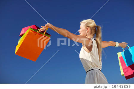 smiling woman with shopping bag rising hands smiling woman with shopping bag rising hands 19445852
