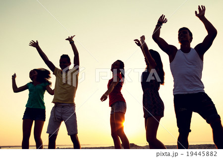 smiling friends dancing on summer beach smiling friends dancing on summer beach 19445882