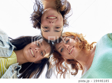 happy young women or teenage girls in circle 19446185