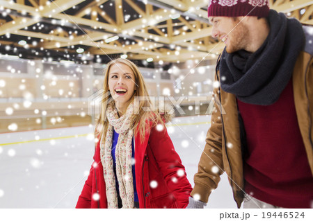 happy couple holding hands on skating rink 19446524