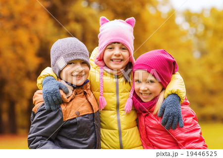 group of happy children hugging in autumn park 19446525