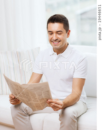 happy man reading newspaper at home happy man reading newspaper at home 19446651