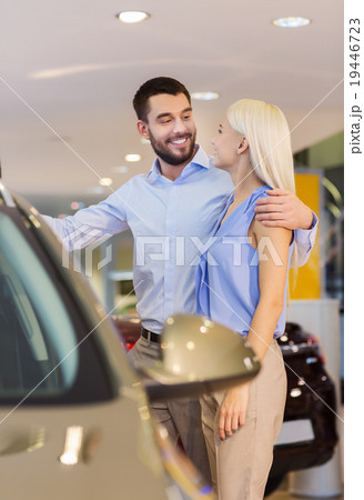 happy couple buying car in auto show or salon 19446723