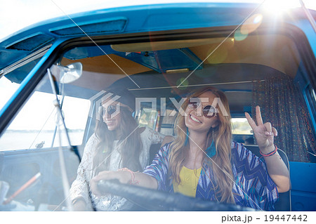 smiling young hippie women driving minivan car 19447442
