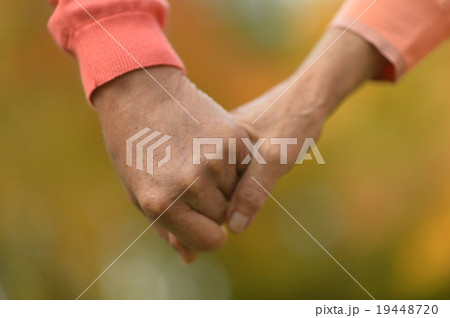 Elderly couple holding hands Elderly couple holding hands 19448720