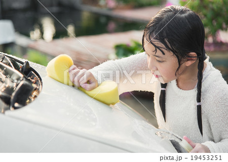 Beautiful asian child washing car Beautiful asian child washing car 19453251