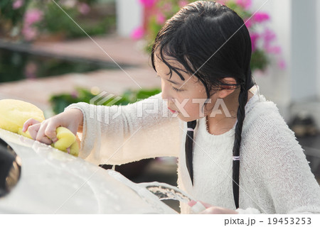 Beautiful asian child washing car Beautiful asian child washing car 19453253