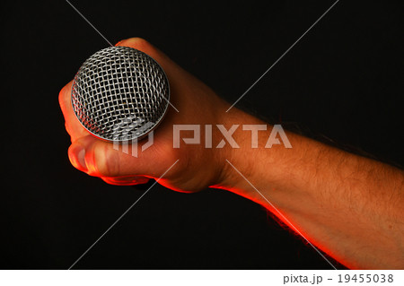 Male hand with microphone and red light on black Male hand with microphone and red light on black 19455038