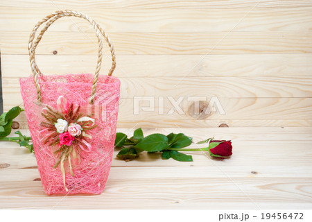 valentine rose with pink bag and wood background valentine rose with pink bag and wood background 19456472