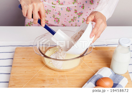 Woman baking and mixing flour with milk Woman baking and mixing flour with milk 19458672