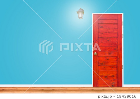 Wooden door and lamp with blue wall texture. 19459016