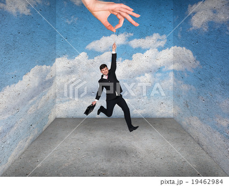 Big hand holding businessman in rough room Big hand holding businessman in rough room 19462984