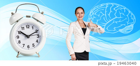 Business woman near classical alarm clock  19463040