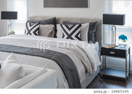 modern bedroom with white bed and black lamp 19465545