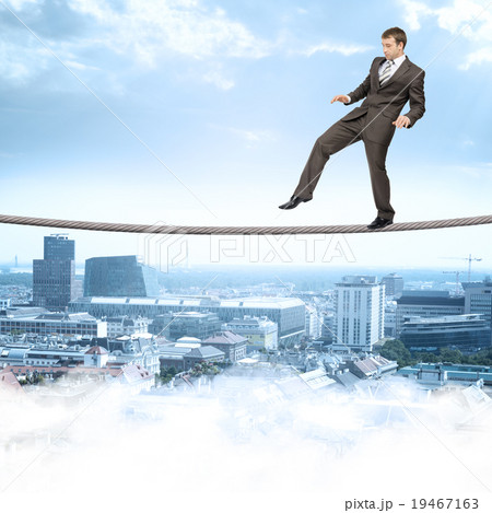 Businessman softly walking on rope Businessman softly walking on rope 19467163