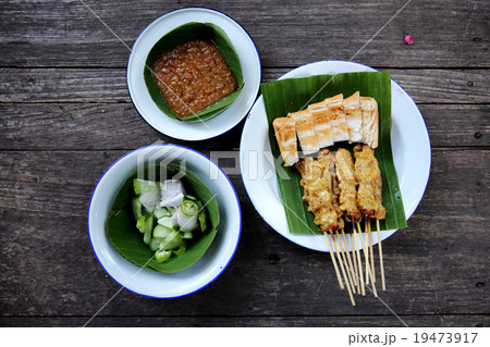 Satay on wood background Satay on wood background 19473917