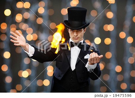 magician in top hat showing trick 19475596