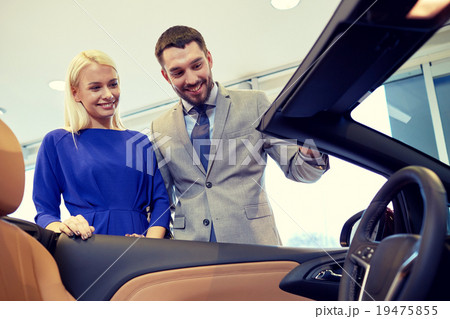 happy couple buying car in auto show or salon happy couple buying car in auto show or salon 19475855