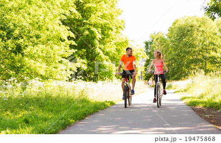 happy couple riding bicycle outdoors 19475868